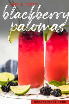 two glasses filled with blackberry paloya and limeade on top of a white plate