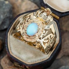 This pierced opal crown ring features a bezel set oval cabochon opal below a crown. The ring is crafted in 10k yellow gold and is a size 7.25. We are not offering resizing due to the design of this ring. The opal has light abrasion but still has a nice play-of-color. Heirloom Gold Opal Gemstone Ring, Gold Ethiopian Opal Heirloom Rings, Heirloom Ethiopian Opal Gold Rings, Heirloom Gold Opal Ring With Cabochon, Heirloom Gold Opal Ring Stamped 14k, Heirloom Gold Opal Cabochon Ring, Heirloom Oval Opal Ring, Yellow Gold Cabochon Opal Ring Collectible, Yellow Gold Cabochon Opal Ring For Collectors