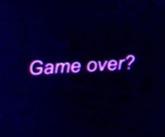 the words game over are lit up against a dark background