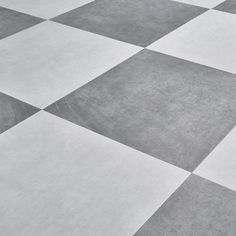 a black and white checkered floor with a skateboard on it