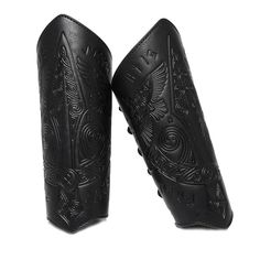 two black leather boots with intricate designs on them