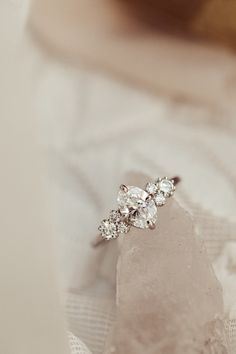 a diamond ring sitting on top of a piece of cloth