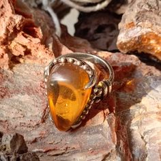 "Handcrafted Silver Baltic Amber Ring - Embrace Nature's Elegance in Rare Baltic Beauty" Greetings, dear visitor, Welcome to our Etsy shop, where craftsmanship meets nature's unique beauty. Today, we are delighted to present to you a true gem from our collection - the Handcrafted Silver Baltic Amber Ring. This exquisite ring is not just a piece of jewelry; it's a wearable masterpiece that reflects the artistry of handmade design. Carefully crafted with love and attention to detail, the silver se Antique Sterling Silver Ring With Large Stone, Unique Amber Sterling Silver Rings, Vintage Sterling Silver Crystal Cabochon Ring, Vintage Sterling Silver Cabochon Crystal Ring, Handmade Vintage Sterling Silver Crystal Ring, Handmade Vintage Citrine Jewelry, Bohemian Amber Sterling Silver Rings, Artisan Amber Ring Jewelry, Antique Amber Gemstone Ring