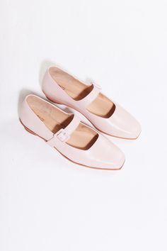 The Eugenia Flat is a modern interpretation of the classic mary jane flat featuring a square toe, angular topline and oval-shaped heel. This pair is crafted from pale pink kidskin leather and a matching buckle.  Who it's for: The woman who is looking for mood-enhancing emotional pieces that defy reason, yet work perfectly with her style and sense of expression.  Kidskin upper and undyed vegetable-tanned leather lining. Leather sole with stacked leather heel measuring 18mm. Handmade in Argentina Modern Mary Janes With Buckle Closure For Spring, Modern Low Heel Mary Janes For Spring, Modern Pointed Toe Mary Janes For Spring, Spring Leather Mary Janes With Square Toe, Leather Mary Janes With Square Toe For Spring, Classic Square Toe Mary Janes For Spring, Classic Pink Round Toe Ballet Flats, Classic Pink Ballet Flats With Round Toe, Classic Spring Mary Janes With Square Toe