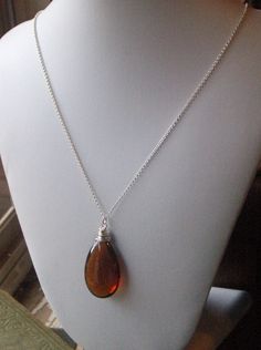 "on reserve for JA do not purchase unless you are she. I am absolutely, genuinely, unequivocally smitten over this dark amber crystal tear drop. I wrapped it in sterling silver wire to keep it pure and simple, for she is beautiful all on her own. She dances freely along 20\" of sterling silver rolo chain. Enjoy! p.s. Exciting news! This exact item went into a celebrity gift bag and was gifted to the beautiful & awesome (and my all-time favorite actress), Zooey Deschanel !! Be on the look out Everyday Brown Sterling Silver Jewelry, Elegant Amber Necklace Nickel-free, Elegant Amber Necklace Nickel Free, Brown Glass Necklace For Gift, Brown Sterling Silver Jewelry For Gifts, Sterling Silver Brown Necklace For Gift, Elegant Brown Sterling Silver Necklace, Sterling Silver Brown Wire Wrapped Jewelry, Brown Teardrop Jewelry For Gift