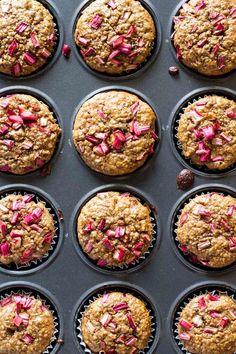 freshly baked muffins with pink sprinkles in a baking pan