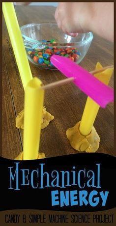 a child is playing with an energy toy on the table in front of a bowl of candy