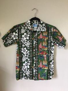 Retrocorrect Vintage Boys Oxford 1980s/1990s Boys RJC made in Hawaii Oxford Hawaiian Shirt *Cotton *Tropical Design *Panel Van / Surf Board Print *Green, White Floral *Band Collar *Coconut Buttons *Single Chest Pocket **Like Father Like Son** Boys Vintage Label Size - 14 Laid Flat Measurements Across Front double chest, waist, hips Chest - 17 3/4" Waist - 17 3/4" Hips - 18" Neck to Shoulder - 5" Sleeve, from shoulder - 8" Back Length, neck to hem - 22 1/2" Back Shoulder Width - 14 1/2" Fabric - Cotton Condition - Excellent True Vintage *like new Thank Youfor being 'retrocorrect' *Reminder Note Please keep in mind, all of my items are 100% authentic vintage. This means they are not new and may show natural signs of wear and age. I do my very best to make note of any and all flaws in the ite Hawaiian Shirt For Beach With Buttons, Vintage Green Camp Shirt For Beach, Vintage Green Camp Shirt For The Beach, Retro Hawaiian Shirt For Beach With Button Closure, Retro Hawaiian Shirt For The Beach, Hawaiian Vacation Shirt With Buttons, Vintage Green Hawaiian Shirt For Summer, Vacation Hawaiian Shirt With Buttons, Green Summer Camp Shirt For Beach