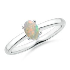 Classic and elegant, this solitaire ring brings all the attention towards the prong-set oval opal and its entrancing play of color. It is crafted in silver and features a plain shank. Oval Opal Rings With Polished Finish, Classic Oval Opal Ring With Polished Finish, Modern Oval Opal Ring, Classic Opal Ring With Polished Oval Cabochon, Classic Opal Ring With Oval Cabochon And Polished Finish, Classic Opal Promise Ring With Polished Finish, Elegant Oval Solitaire Opal Ring, Formal Oval Solitaire Opal Ring, Classic Oval Opal Ring