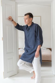 "A classic style redefined with modern styling, we created a linen tunic for men to fill that gap in your everyday wardrobe. The linen shirts are breathable and durable to provide maximum comfort, and they've kept it simple with roll-up sleeves and button-up closure. Step out in style no matter the occasion with a little help from our signature linen tunic. Handmade by masters of their craft in Lithuanian, where skills have been passed down for generations, your wardrobe's latest addition is sur Tunic Designs Men, Relaxed Fit Long Sleeve Linen Kurta, Casual Linen Kurta With Relaxed Fit, Casual Linen Kurta For Summer, Casual Linen Kurta Tunic, Summer Linen Kurta Tunic, Casual Linen Tunic Kurta, Summer Linen Tunic Kurta, Summer Linen Kurta With Relaxed Fit