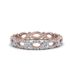 a rose gold wedding band with round cut diamonds in the center and an oval design on each side