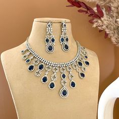 Faux diamond  sapphire blue necklace with matching earring. Delicate diamond necklace is in teardrop shape  with white gold finish to glam you up for your special occasion.   All orders Ship same day if placed before 4:00 PM EST  Earring Length: 2.5 inch Earring Width: 0.75 inch Necklace Length: 15-17 Create beautiful memory for any occasion with elegant jewelry for your loved ones We will be happy to navigate you through the process so if you have any questions regarding our product before plac Blue Necklace Set, Delicate Diamond Necklace, Necklace Indian, Diamond Necklace Set, Wedding Jewellery Necklace, Pakistani Wedding, Blue Necklace, Sapphire Blue, Elegant Jewelry