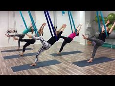 a group of women doing aerial yoga exercises