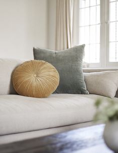 a white couch with two pillows on top of it