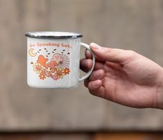 a person holding a coffee mug with an image on it