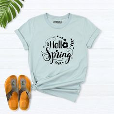 Hello Spring Shirt, spring shirts for women, Easter Shirts, Floral Spring T-Shirt, Spring Flowers Shirt, spring day t-shirt, spring clothing Hello! Thank you for supporting small businesses. My main priority here is the satisfaction of my customers. My t-shirts are Bella+Canvas brand. If Bella+Canvas is out of stock, I will send it from a brand of the same size and quality. If you want to see this design on the SWEATSHIRT you can buy it from the link below.https://etsy.me/3LS0Viz T-shirts are co Spring Letter Print Short Sleeve T-shirt, Green Casual T-shirt For Spring, Trendy Spring Tops With Letter Print, Spring Graphic Tee Cotton Tops, Spring Cotton Graphic Tee Tops, Spring Crew Neck Graphic Tee, Spring Cotton T-shirt With Graphic Print, Spring Graphic Tee With Crew Neck, Spring Letter Print T-shirt With Relaxed Fit