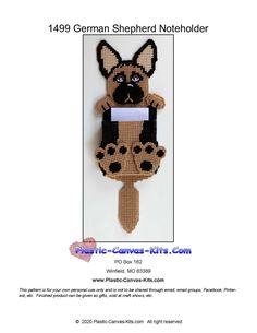 a cross stitch pattern for a german shepherd dog hanging on a doorknobl