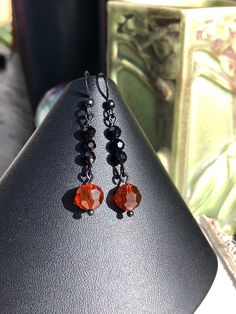 "These simple but elegant earrings were made to match the Black Red Orange Multi Strand Art Deco Style Necklace w/ Heart Pendant Pendant and Bracelet. Made with jet black 4mm round crystals and 8mm round faceted round crystals. Black coated brass ear hooks. Length: 1 7/8\" Matching pieces available: Heart Pendant Necklace: https://www.etsy.com/listing/896700815/black-red-orange-multi-strand-art-deco Bracelet https://www.etsy.com/listing/898954585/black-red-orange-multi-art-deco-style" Strand Art, Crystals Black, Art Nouveau Earring, Art Deco Bracelet, Deco Earrings, Earrings Art, Vintage Style Earrings, Orange Earrings, Art Deco Earrings