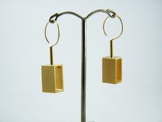 "Geometric gold statement earrings, Movement jewelry, Gold Rectangle dangle earrings, Kinetic earrings. Sophisticated Geometric statement earrings. SGolden rectangles earrings part of my new\"kinetic jewelry \"collection that influenced by geometric architecture and mainly Inspired by Kinetic Art - \"Kinetic art is art from any medium that contains movement perceivable by the viewer or depends on motion for its effect.\" These earrings consists golden rectangles + goldfilled tube connected to a Kinetic Earrings, Movement Jewelry, Kinetic Jewelry, Geometric Architecture, Kinetic Art, Rectangle Earrings, Gold Statement Earrings, Jewelry Gold, Candle Sconces