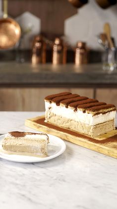 a piece of cake sitting on top of a white plate next to a slice of cake