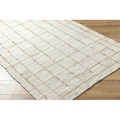 a white rug on the floor with wooden floors