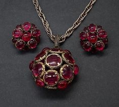 "Gorgeous Highly Collectible Vintage Art Deco Crown Trifari Renaissance Pendant Necklace, Earring Set Crown Trifari Faux Ruby Glass Double Sided Molded Glass Necklace Set Good Pre/owned Condition Chain Measures 20\" and the Pendant Measures 2\" with bale and the earrings are 1\" perfect to add in your collection." Luxury Glass Jewelry For Party, Luxury Glass Jewelry For Formal Occasions, Elegant Glass Jewelry With Cabochon, Vintage Glass Jewelry With Matching Earrings, Silver Glass Evening Jewelry, Silver Glass Jewelry For Evening, Evening Silver Glass Jewelry, Evening Costume Jewelry With Cabochon, Evening Cabochon Costume Jewelry