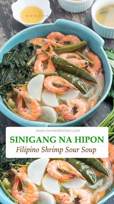 a blue bowl filled with shrimp and veggies on top of a wooden table