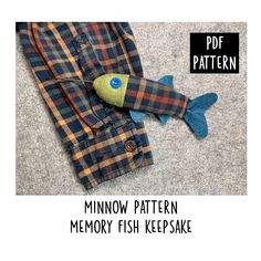 an image of a fish toy on the floor with text overlay that reads, minnow - pattern memory fish keepsake