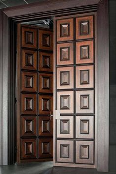 an open wooden door with glass inserts