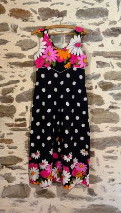 1970s long floral black dress. Lovely vintage Marie Bonheur of Paris. Bold flowers in pink, fuschia, orange, white with green on black background. Sleeveless, with an angled scooped neckline, bodice has white piping, zipper closure on the back.  With original tag. Says size 40 but more of a 38.  Made in France.  Measurements: Shoulder 34cm Bodice 37cm Length 119cm Size 38/40 I am happy to give a quote for combined shipping costs if you are interested in several items. I will refund any extra pos Black Long Dress, Bold Flowers, French Flowers, Long Black Dress, Floral Dress Black, Dress Vintage, Vintage French, Dress Clothes For Women, French Vintage