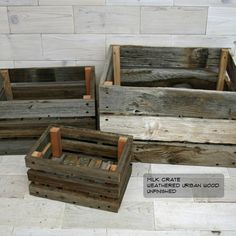 three wooden crates sitting on top of a white tile floor