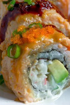 there is a sushi roll on the plate with cucumbers and sauces