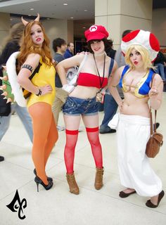 three women dressed up in costumes standing next to each other