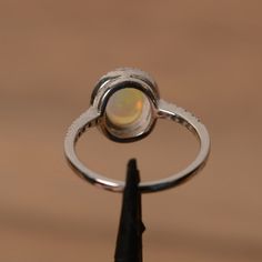 It is a natural opal ring. The main stone is 7mm*9mm oval white opal. The basic metal is sterling silver and plated with rhodium. To change the metal to a solid gold (white/rose) or platinum is also available, please ask for a quotation if you want. You can also go to my shop Home for more elegant rings: https://www.etsy.com/shop/godjewelry?ref=hdr_shop_menu Opal is the birthstone of October, it will be a great gift for your lover! Customization is always welcome and please feel free to contact Ethiopian Opal Oval Ring For Wedding, Oval Opal Rings With Polished Finish, Fine Jewelry Oval Opal Ring With Polished Finish, Oval Opal Ring With Polished Finish In Fine Jewelry, Oval Opal Ring With Polished Finish, Opal Oval Cabochon Ring With Polished Finish, Polished Opal Ring In Oval Cabochon Shape, Polished Opal Oval Cabochon Ring, Opal Ring With Bezel Setting