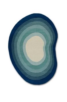 a blue and white rug with an oval shape in the center on a white background