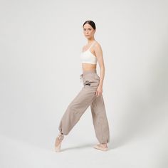 Let's fall in love with Bosaddo aesthetic CREAM warm-up pants. This fashion activewear outfit is the perfect choice for your dance classes and rehearsals. Trash bag style sports pants are perfect for ballet, contemporary or ballroom dances, pilates, gym training, sports or just casual wear.  👇🏼 ABOUT PANTS:  Fashion Bosaddo dancewear is made in the E.U. using top-notch materials. Our Cream warm-up pants are made of carefully selected heat-retaining fabric. We really focus not only on fashionable and stylish part, but also on functionality and a luxurious sense of comfort.    Please refer to the size chart to select your preferred size. 👊 The hand-picked selection of materials. 👊 Ergonomic design and tailor-made.  👊 Baggy fit, full length. 👊 Elasticated waist and adjustable ankle.  👊 Beige Full-length Harem Pants With Pockets, Yoga Cargo Pants With Elastic Waistband, Stretch Balletcore Bottoms, High-waisted Harem Pants With Pockets For Yoga, Full Length Dancewear Bottoms, Baggy Full-length Beige Harem Pants, Fitted Balletcore Dance Bottoms, Beige Stretch Cotton Harem Pants, Yoga Pants With Pockets And Tapered Leg