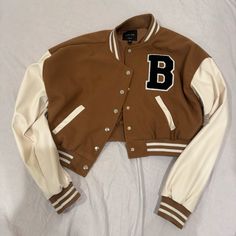 New With Tag Cheap Winter Varsity Jacket With Button Closure, Trendy Brown Varsity Jacket For Winter, Trendy Brown Varsity Jacket For College, Brown Varsity Outerwear For Fall, Trendy Brown Long Sleeve Varsity Jacket, Sporty Brown Spring Outerwear, Sporty Brown Outerwear For Spring, Brown Fluffy Jacket, Cropped Baseball Jacket