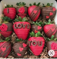 chocolate covered strawberries in a box with i love you written on the top one