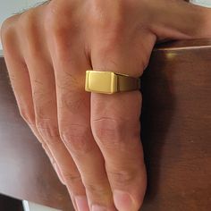 Gold Rectangle Signet Ring for men and women. Gold personalized signet ring for men and women. This minimalist signet ring is the perfect choice to buy as a gift for your loved ones. You can personalize the ring by engraving your desired word, name, sign, or number. Rings come in 4 sizes.  Specifications: * Rectangle Size: 15 x 10 mm * Metal type: Stainless steel * Finish: 14K Gold plated * Available sizes: 8 US/CA, 9 US/CA, 10 US/CA, 11 US/CA How to order: * Select desired size  * Select desire Rectangle Signet Ring, Number Rings, Signet Ring For Men, Engraved Ring, Monogram Ring, Signet Rings, Men Diamond Ring, Personalized Rings, Men's Rings