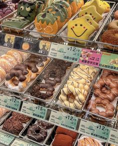 a display case filled with lots of different types of doughnuts and pastries