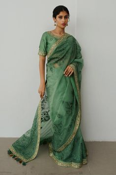 Moss green organza saree with aari hand embroidery. Comes with a blouse.
Components: 2
Pattern: Hand embroidered
Type Of Work: Aari
Neckline: Round
Sleeve Type: Half
Fabric: Organza
Color: Green
Other Details: 
Note : Outfit worn by the model on the left is not for sale.
Occasion: Sangeet - Aza Fashions Embroidered Pista Green Pre-draped Saree For Reception, Green Chanderi Pre-draped Saree For Festivals, Pista Green Organza Pre-draped Saree For Diwali, Traditional Pista Green Organza Pre-draped Saree, Pista Green Cotton Silk Pre-draped Saree For Wedding, Green Choli With Zari Work In Traditional Drape, Traditional Green Zari Work Choli, Traditional Green Pre-draped Saree With Sheer Dupatta, Green Embroidered Pre-draped Saree For Reception