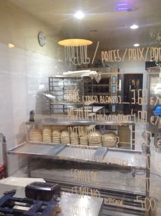 the inside of a restaurant kitchen with lots of food on display in front of it