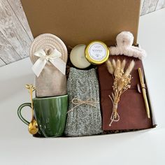 an open box containing items from the holiday season, such as socks and mugs