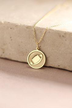 Gold American Football Pendant - American Football Ball Gold Necklace ● Material of pendant: Solid Gold 14k ( REAL GOLD ) ● Metal Stamp: 14k ( REAL GOLD ) ● The pendant is available in 5 sizes: - 12,7 mm / 0.5 inches (Diameter) - 14,0 mm / 0,55 inches ( Diameter ) In the photos - 15,3 mm / 0.6 inches ( Diameter ) - 16,5 mm / 0,65 inches ( Diameter ) - 19,1 mm / 0,75 inches ( Diameter ) ( In the photos the size is 14mm / 0.55 inches Diameter ) ( Jump Ring inner diameter: 4 mm ) ● Material of chai Gold Sterling Silver Custom Necklace With Charms, White Gold Plated Charm Necklace With Round Pendant, White Gold Plated Round Pendant Charm Necklace, Custom Silver Necklace Stamped 14k, Personalized Round Gold Plated Charm Necklaces, Personalized Gold-plated Charm Necklaces, Personalized Gold Plated Charm Necklaces, Personalized Yellow Gold Charm Necklace For Birthday, 14k Gold Necklaces With Round Pendant Charms