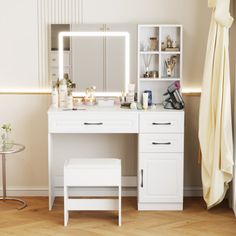 a white dressing table with mirror and stool in front of it on top of a hard wood floor