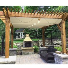 an outdoor fireplace and grill in the middle of a patio