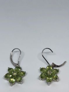 Vintage antique design dangle earrings Main stone Peridot Lovely handmade silver work 92.5% Sterling Silver All jewelry is shipped in a nice gift box. Check out our over a THOUSAND great reviews Green Lever Back Earrings As A Gift, Sterling Silver Lever Back Earrings For Anniversary, Fine Jewelry Lever Back Earrings For Gift, Green Formal Earrings With Ear Wire, Green Sterling Silver Earrings With Ear Wire, Green Sterling Silver Earrings For May Birthstone, Green Sterling Silver Flower Drop Earrings, Green Hallmarked Fine Jewelry Earrings, Green Nickel-free Flower-shaped Jewelry