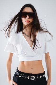 Elevate your spring and summer wardrobe with this chic White Crop Top, designed to offer both comfort and style. The top features short sleeves and a flattering V-neck, making it an ideal choice for warm weather. Its drawstring closure at the bottom allows for a customizable fit, adding a playful and adjustable element to your outfit. The cropped length and bodycon fit ensure it pairs perfectly with high-waisted jeans, skirts, or shorts, making it a versatile addition to your closet.  Crafted from 100% polyester, this top is both lightweight and durable, providing a comfortable wear that keeps you cool during the warmer months. The open back adds an extra touch of allure, making it perfect for parties or casual outings. The lightweight woven fabric enhances its breathability, ensuring you Crop Top Blanco, Tan Scarf, Skirt Jumpsuit, Scarf Headband, White Crop, Romper Pants, White Crop Top, Sweater Coats, Large White