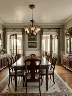 a dining room table with chairs and a chandelier