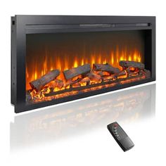 an electric fireplace with fire logs and remotes next to it on a white background